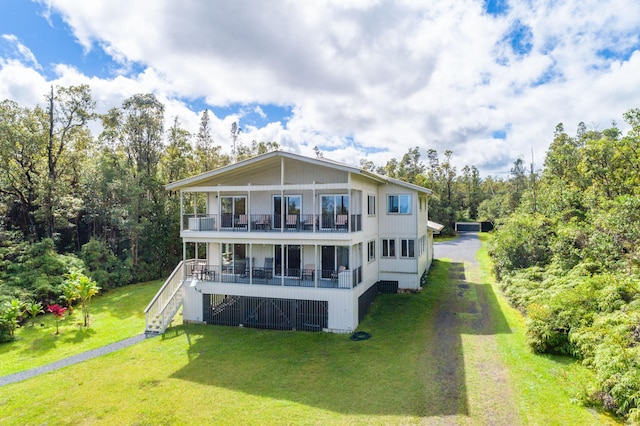11-3064 Lehua St, Mountain View, HI 96771 - back of property with stairway, a lawn, driveway, a balcony, and a porch