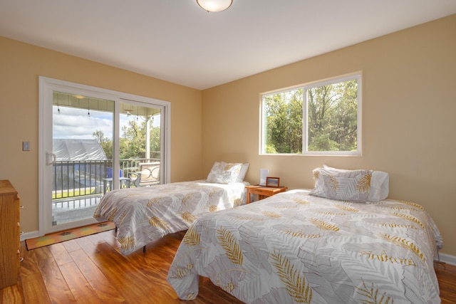 11-3064 Lehua St, Mountain View, HI 96771 - bedroom featuring access to exterior, multiple windows, wood finished floors, and baseboards