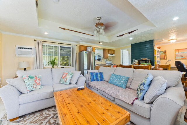 15-2059 10th Ave, Keaau, HI 96749 - living room featuring a raised ceiling, an AC wall unit, recessed lighting, ceiling fan, and ornamental molding