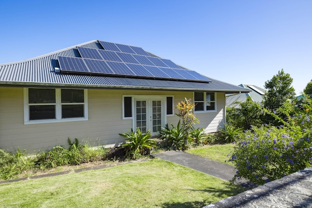 55-3449 Akoni Pule Hwy, Hawi, HI 96719 - view of front of house featuring french doors, solar panels, a front lawn, and metal roof