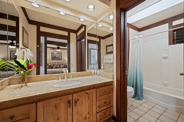 2253 Poipu Rd Unit 109, Koloa, HI 96756 - bathroom with toilet, a ceiling fan, vanity, tile patterned flooring, and shower / bath combination with curtain