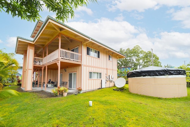 12-7059 Puulena St, Pahoa, HI 96778 - rear view of property featuring board and batten siding, a yard, a patio, and a balcony