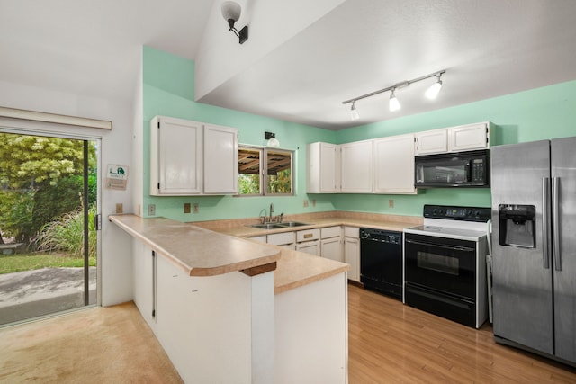 4833 Ou Pl, Princeville, HI 96722 - kitchen featuring black appliances, a sink, a peninsula, and white cabinetry