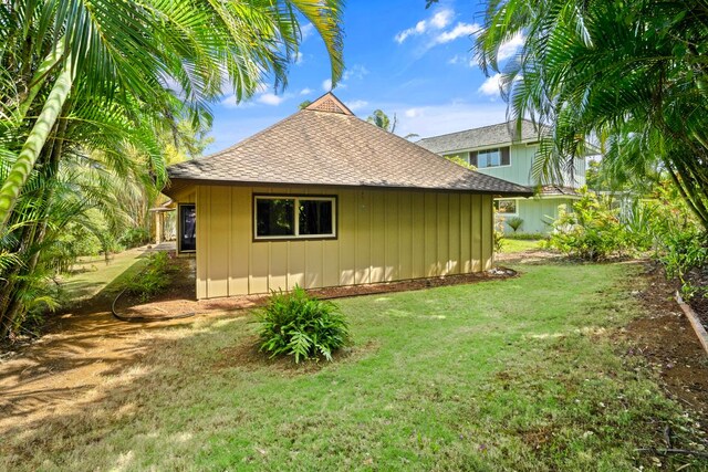 4833 Ou Pl, Princeville, HI 96722 - view of property exterior featuring roof with shingles, a lawn, and board and batten siding