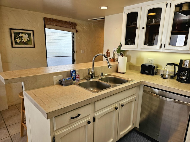 75-6082 Alii Dr Unit A201, Kailua-Kona, HI 96740 - kitchen with dishwasher, a sink, a peninsula, glass insert cabinets, and white cabinets