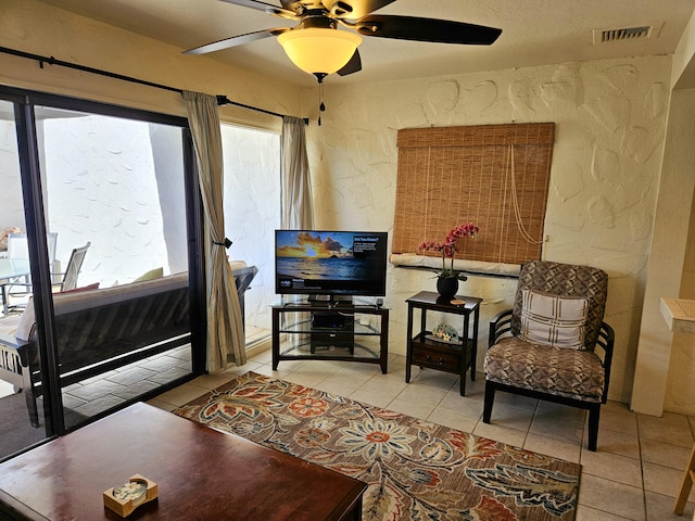75-6082 Alii Dr Unit A201, Kailua-Kona, HI 96740 - living room with light tile patterned floors, a ceiling fan, healthy amount of natural light, and a textured wall