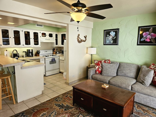 75-6082 Alii Dr Unit A201, Kailua-Kona, HI 96740 - living room with light tile patterned flooring and a ceiling fan