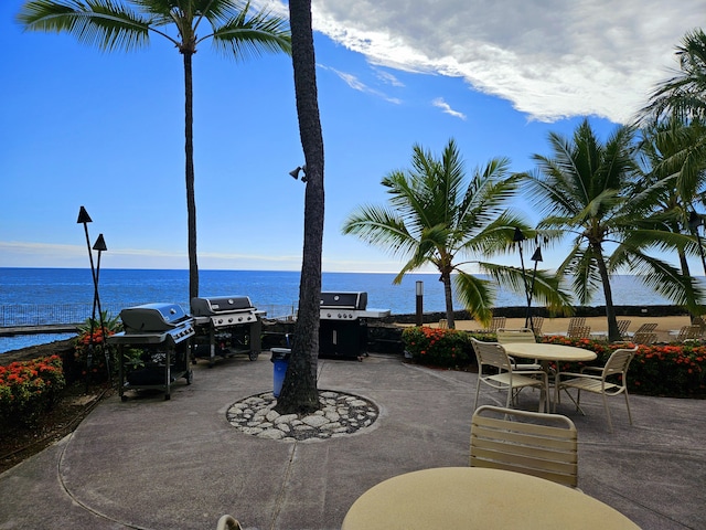 75-6082 Alii Dr Unit A201, Kailua-Kona, HI 96740 - view of patio / terrace featuring area for grilling, a water view, and outdoor dining space
