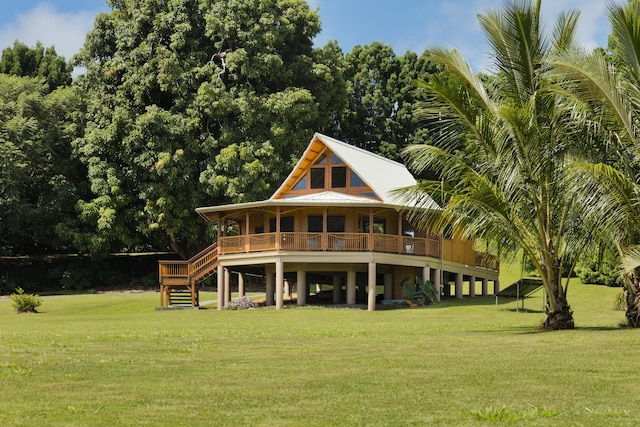 28-3033 Beach Rd, Pepeekeo, HI 96783 - rear view of property with a lawn, stairs, and metal roof