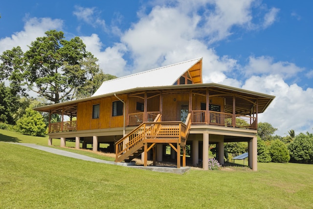 28-3033 Beach Rd, Pepeekeo, HI 96783 - rear view of house with a yard, metal roof, and stairs
