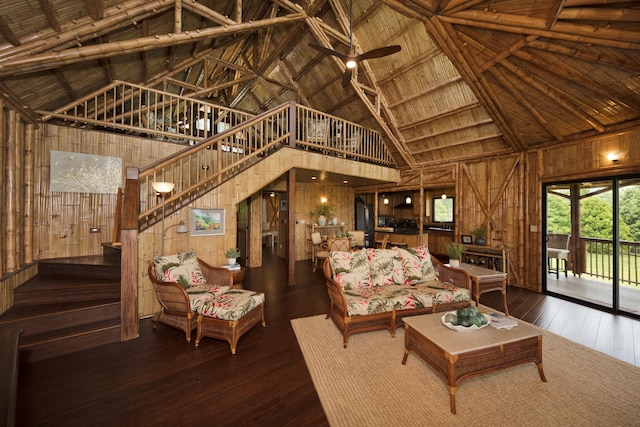 28-3033 Beach Rd, Pepeekeo, HI 96783 - living area featuring high vaulted ceiling, wooden walls, stairway, wood ceiling with exposed beams, and hardwood / wood-style flooring