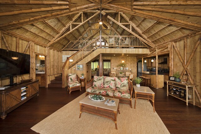28-3033 Beach Rd, Pepeekeo, HI 96783 - living room featuring high vaulted ceiling, wood walls, stairway, wood finished floors, and wooden ceiling with exposed beams