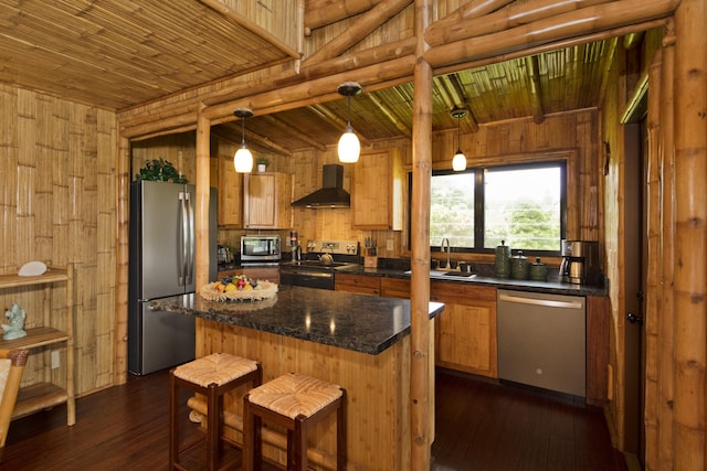 28-3033 Beach Rd, Pepeekeo, HI 96783 - kitchen with stainless steel appliances, wall chimney exhaust hood, wooden walls, dark wood-style floors, and brown cabinetry
