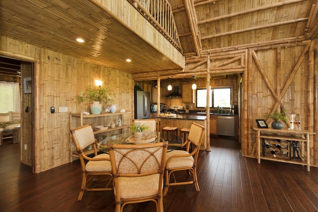 28-3033 Beach Rd, Pepeekeo, HI 96783 - dining room featuring wood walls, wooden ceiling, dark wood finished floors, and high vaulted ceiling