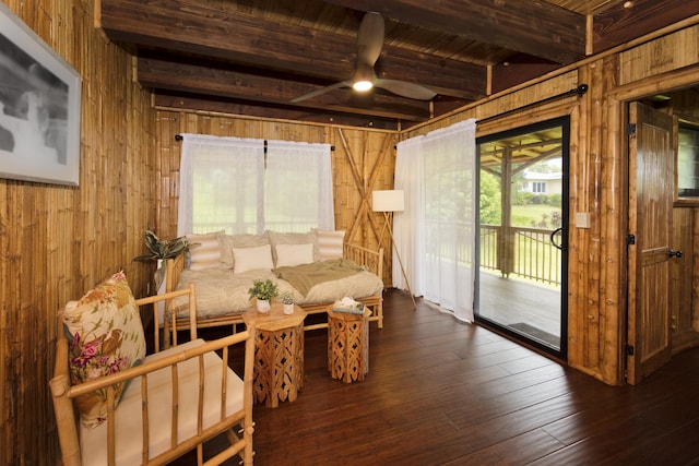 28-3033 Beach Rd, Pepeekeo, HI 96783 - living area featuring wood walls, a ceiling fan, dark wood-style floors, and wood ceiling with exposed beams