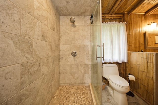 28-3033 Beach Rd, Pepeekeo, HI 96783 - full bathroom featuring tiled shower, toilet, and wooden walls