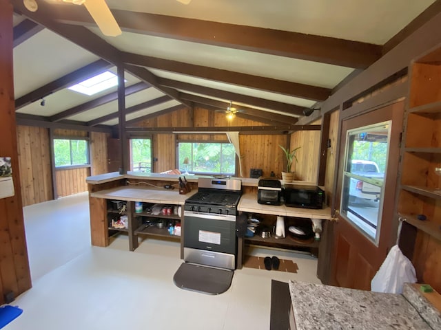 15-2773 Ono St, Pahoa, HI 96778 - kitchen with stainless steel range with gas stovetop, black microwave, wooden walls, and a ceiling fan
