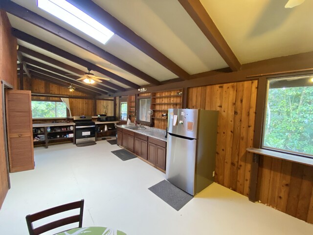 15-2773 Ono St, Pahoa, HI 96778 - kitchen with appliances with stainless steel finishes, wood walls, a sink, and light countertops