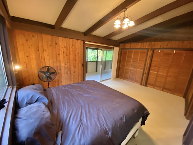 15-2773 Ono St, Pahoa, HI 96778 - bedroom with wooden walls, a chandelier, access to outside, and carpet flooring