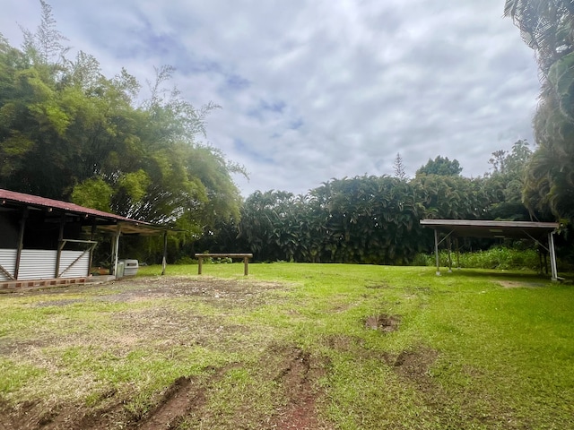 1395 Ainaola Dr, Hilo, HI 96720 - view of green lawn featuring a wooded view