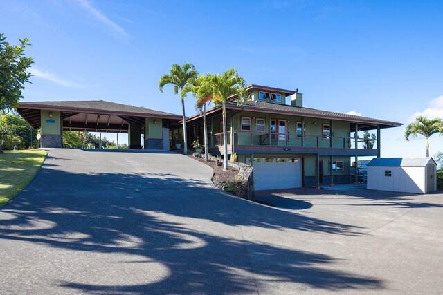 74-1026 Lawaia Rd, Holualoa, HI 96725 - view of front facade with concrete driveway, a balcony, and a garage