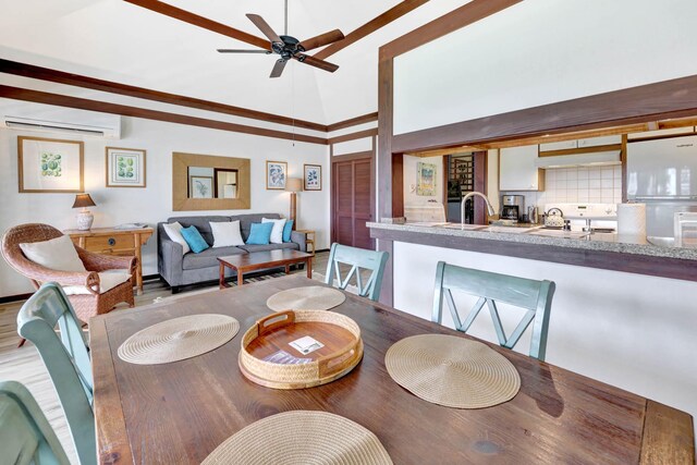 2253 Poipu Rd Unit 138, Koloa, HI 96756 - dining space with a wall mounted AC, ceiling fan, and a high ceiling