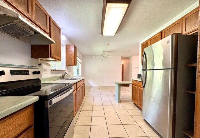 15-2689 Maikoiko St, Pahoa, HI 96778 - kitchen with stainless steel appliances, under cabinet range hood, a sink, brown cabinets, and a textured ceiling