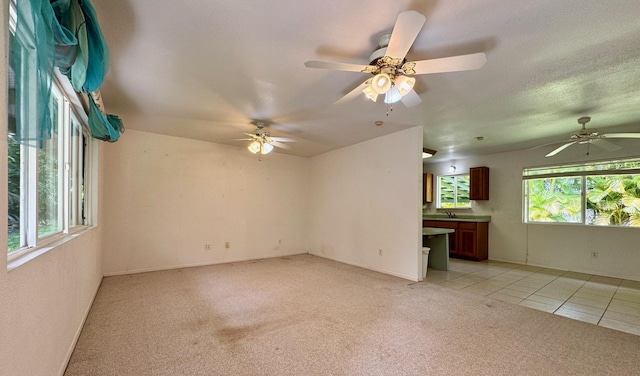15-2689 Maikoiko St, Pahoa, HI 96778 - unfurnished living room with light carpet, light tile patterned floors, a sink, and a ceiling fan