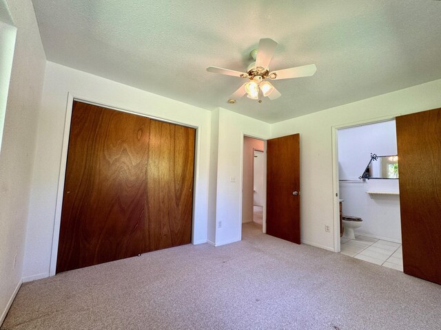 15-2689 Maikoiko St, Pahoa, HI 96778 - unfurnished bedroom with a closet, carpet flooring, ensuite bathroom, a ceiling fan, and baseboards