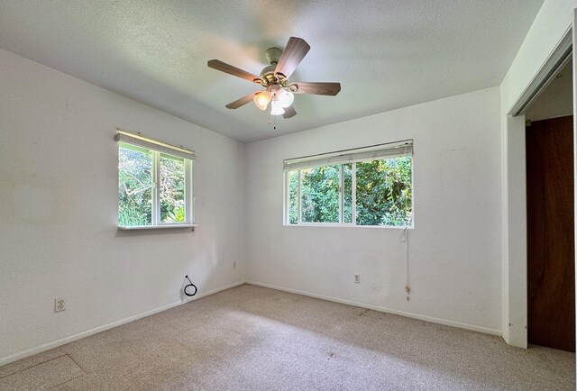 15-2689 Maikoiko St, Pahoa, HI 96778 - unfurnished bedroom featuring light carpet, a textured ceiling, baseboards, and ceiling fan