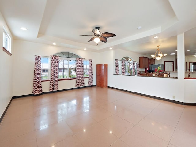 2089 Kinoole St, Hilo, HI 96720 - unfurnished living room with a tray ceiling, a chandelier, baseboards, recessed lighting, and a ceiling fan