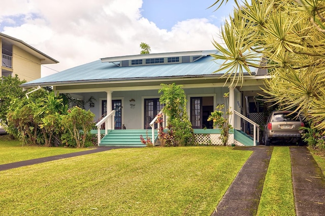 338 Kauila St, Hilo, HI 96720 - view of front facade featuring a front lawn, covered porch, and metal roof