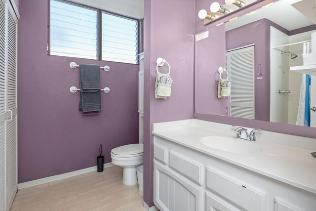 78-6800 Alii Dr Unit 6301, Kailua-Kona, HI 96740 - full bathroom with toilet, vanity, wood finished floors, baseboards, and a shower