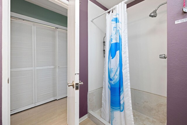 78-6800 Alii Dr Unit 6301, Kailua-Kona, HI 96740 - full bath with a shower stall, a closet, and wood finished floors