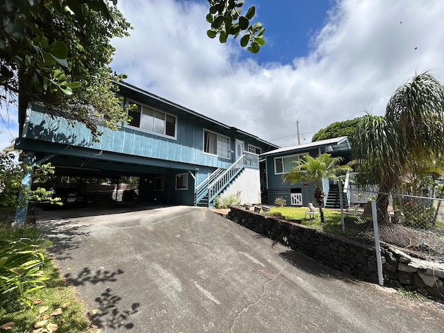 74-5114 Kumakani St, Kailua-Kona, HI 96740 - view of front facade with stairway, asphalt driveway, and a carport