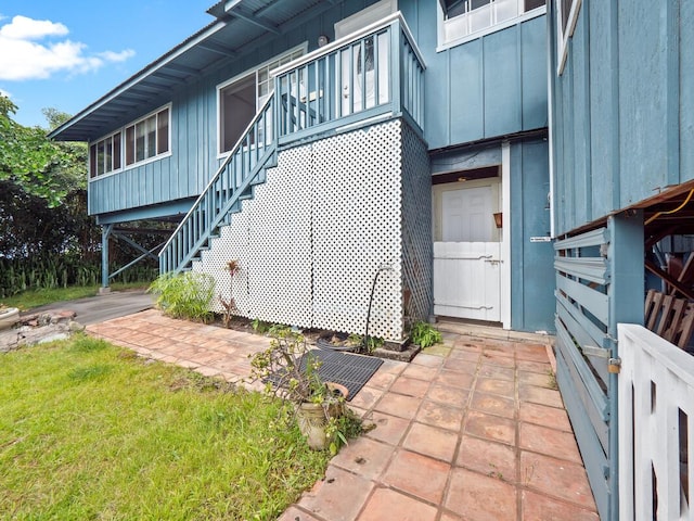 74-5114 Kumakani St, Kailua-Kona, HI 96740 - view of side of home featuring board and batten siding and stairway
