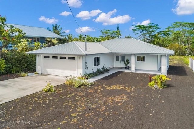 15-1517 Beach Rd, Keaau, HI 96749 - ranch-style house with driveway, a garage, metal roof, and stucco siding