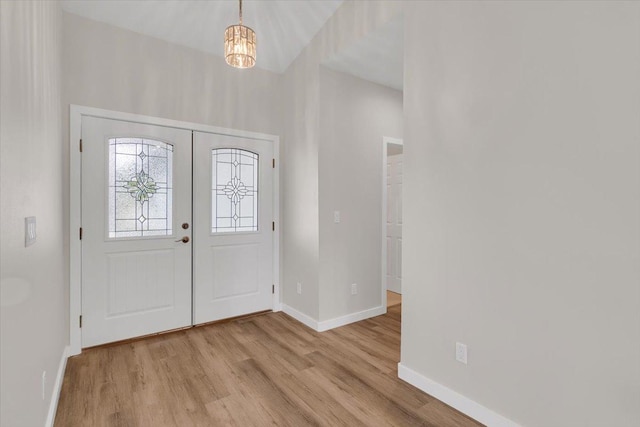 15-1517 Beach Rd, Keaau, HI 96749 - entryway with wood finished floors, baseboards, and a chandelier