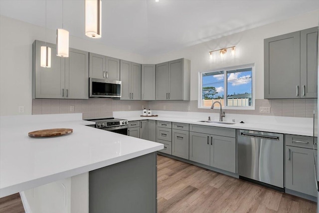 15-1517 Beach Rd, Keaau, HI 96749 - kitchen featuring stainless steel appliances, gray cabinetry, a sink, a peninsula, and light countertops