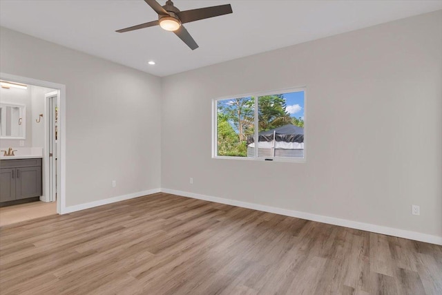 15-1517 Beach Rd, Keaau, HI 96749 - unfurnished bedroom with light wood-type flooring, baseboards, a sink, recessed lighting, and ensuite bathroom