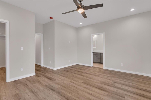 15-1517 Beach Rd, Keaau, HI 96749 - unfurnished bedroom featuring a spacious closet, light wood-style flooring, baseboards, recessed lighting, and connected bathroom
