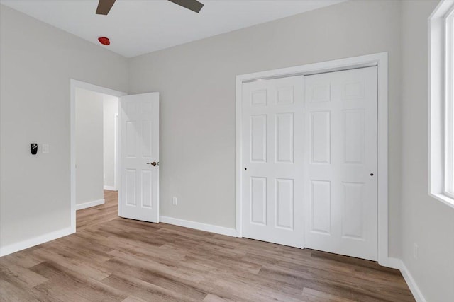 15-1517 Beach Rd, Keaau, HI 96749 - unfurnished bedroom with wood finished floors, a closet, baseboards, and a ceiling fan