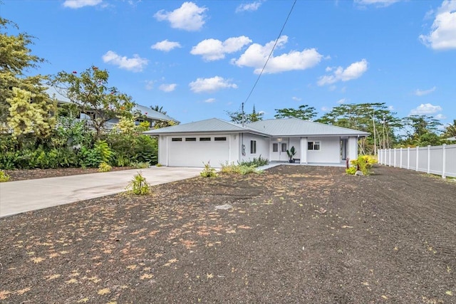 15-1517 Beach Rd, Keaau, HI 96749 - view of front facade with concrete driveway, an attached garage, a porch, and metal roof