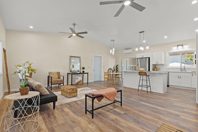3905 Kila Pl, Hilo, HI 96720 - living area with ceiling fan, a wall mounted air conditioner, light wood-type flooring, recessed lighting, and vaulted ceiling