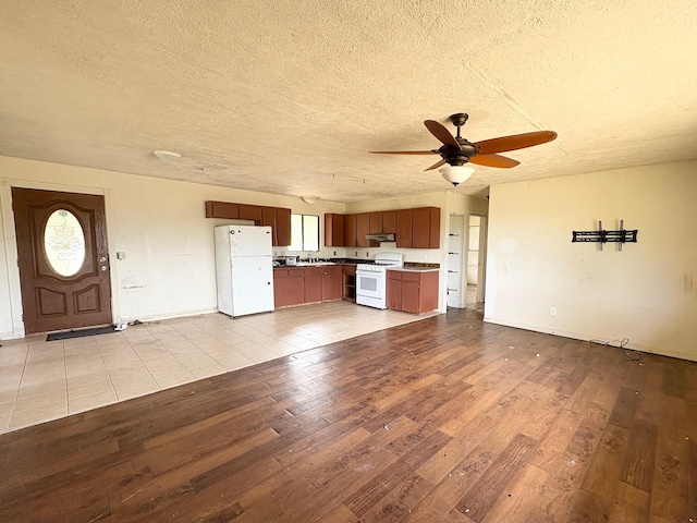 15-1698 19th Ave, Keaau, HI 96749 - unfurnished living room with a textured ceiling, a ceiling fan, wood finished floors, and baseboards