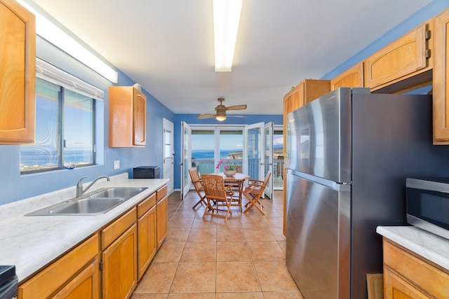 88-198 Aoao Ave, Captain Cook, HI 96704 - kitchen with stainless steel appliances, a sink, light countertops, light tile patterned flooring, and ceiling fan