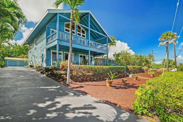 1650 Makanui Rd, Koloa, HI 96756 - view of front of home featuring a balcony, an outbuilding, and a garage