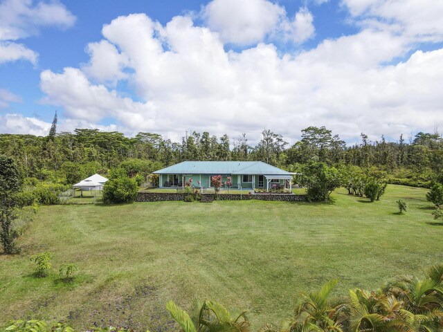 16-484 Laniuma St, Keaau, HI 96749 - view of green lawn with a view of trees and a porch