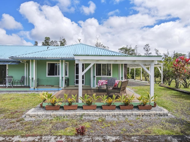 16-484 Laniuma St, Keaau, HI 96749 - view of front of property with a front yard, metal roof, and a porch