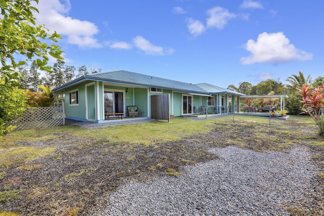 16-484 Laniuma St, Keaau, HI 96749 - back of house with metal roof and a patio area